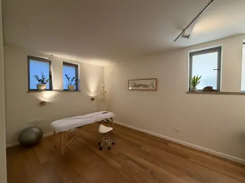 חדר טיפולים מעוצב עם מיטת טיפולים ושלד אנטומי